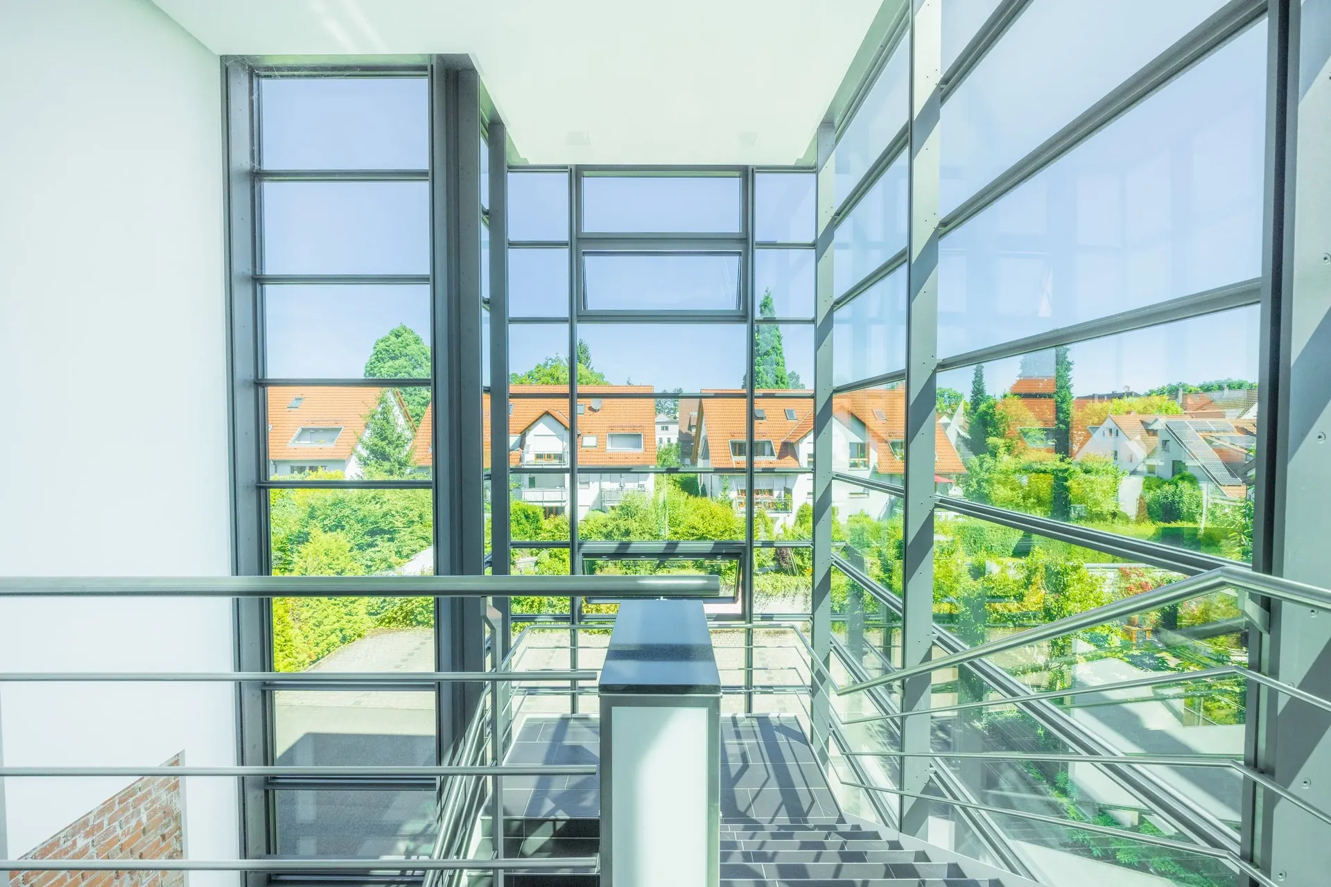 Verglastes Treppenhaus mit Blick über Satteldächer und Grünflächen — Aufnahme aus der Region Ulm, MV Media